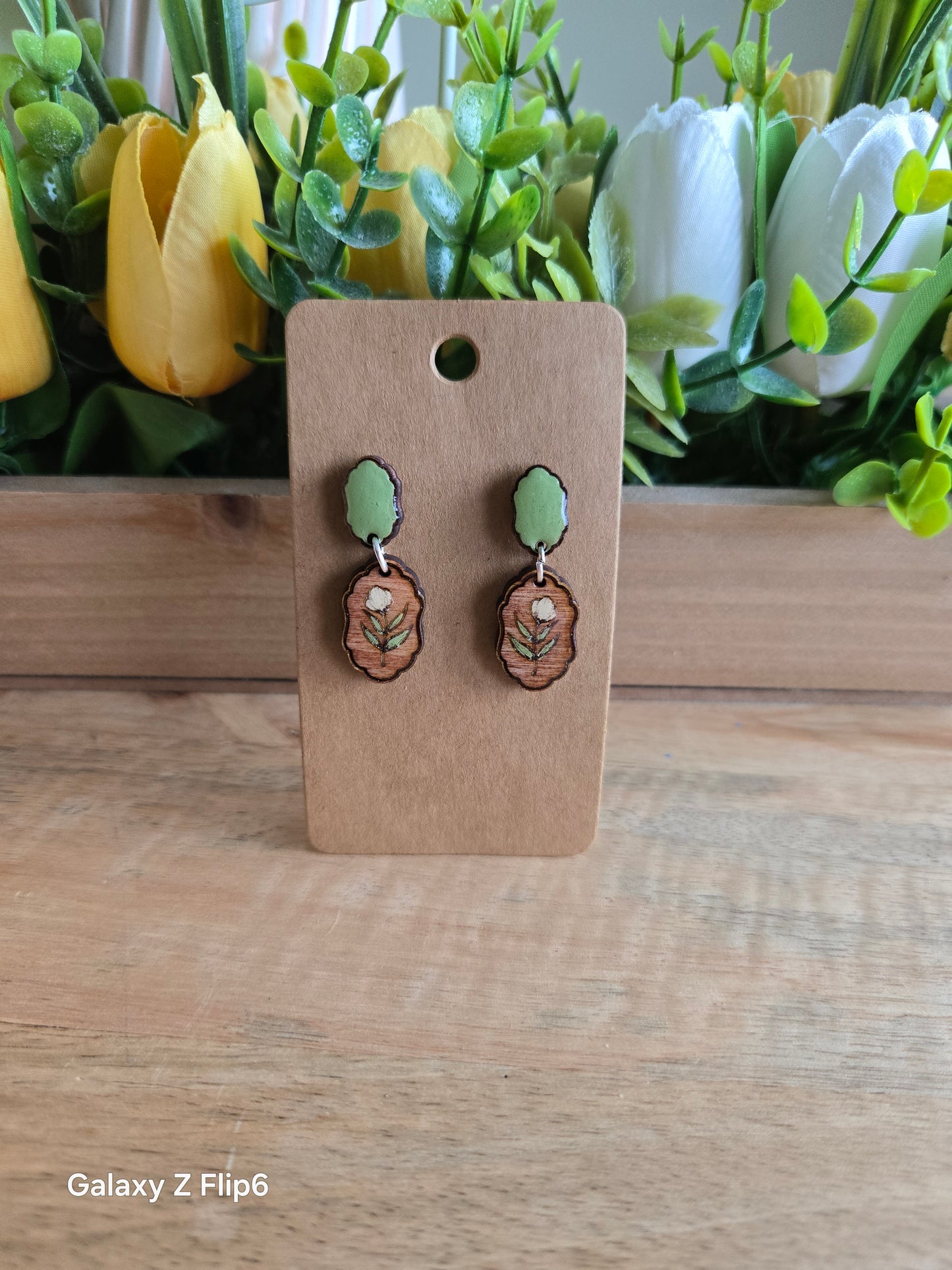 Green studs with cream flower
